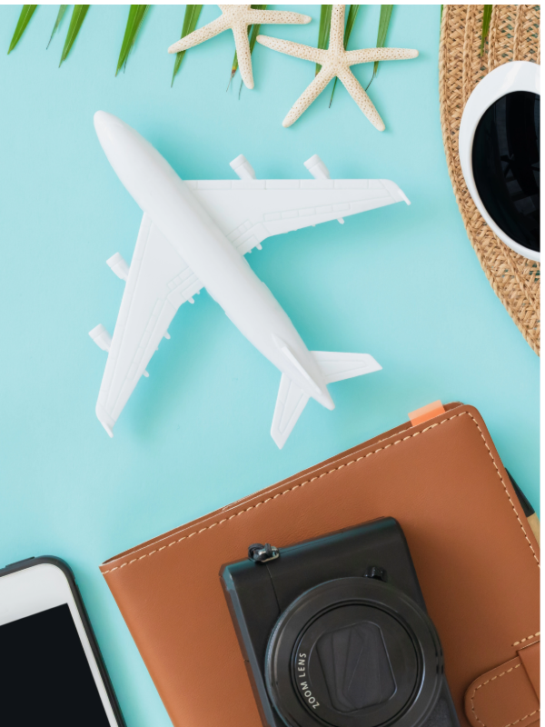 Foto von oben mit Miniaturflugzeug, Kamera und Notizblock